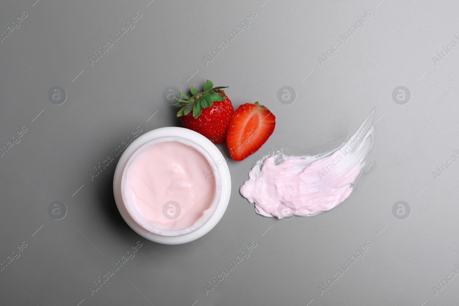 Photo of Flat lay composition with jar of body cream on grey background