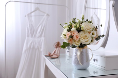Photo of Beautiful wedding bouquet on dressing table indoors