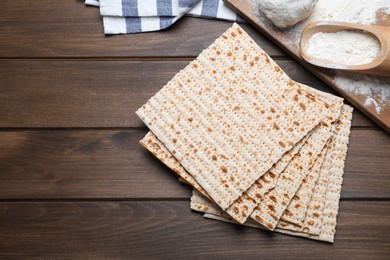 Photo of Stack of matzos on wooden table, flat lay