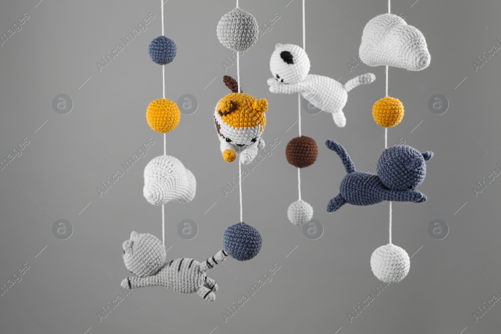 Photo of Cute baby crib mobile on grey background