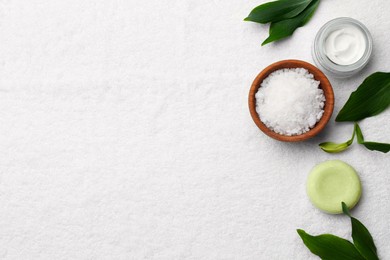 Photo of Flat lay composition with spa products and leaves on white towel. Space for text