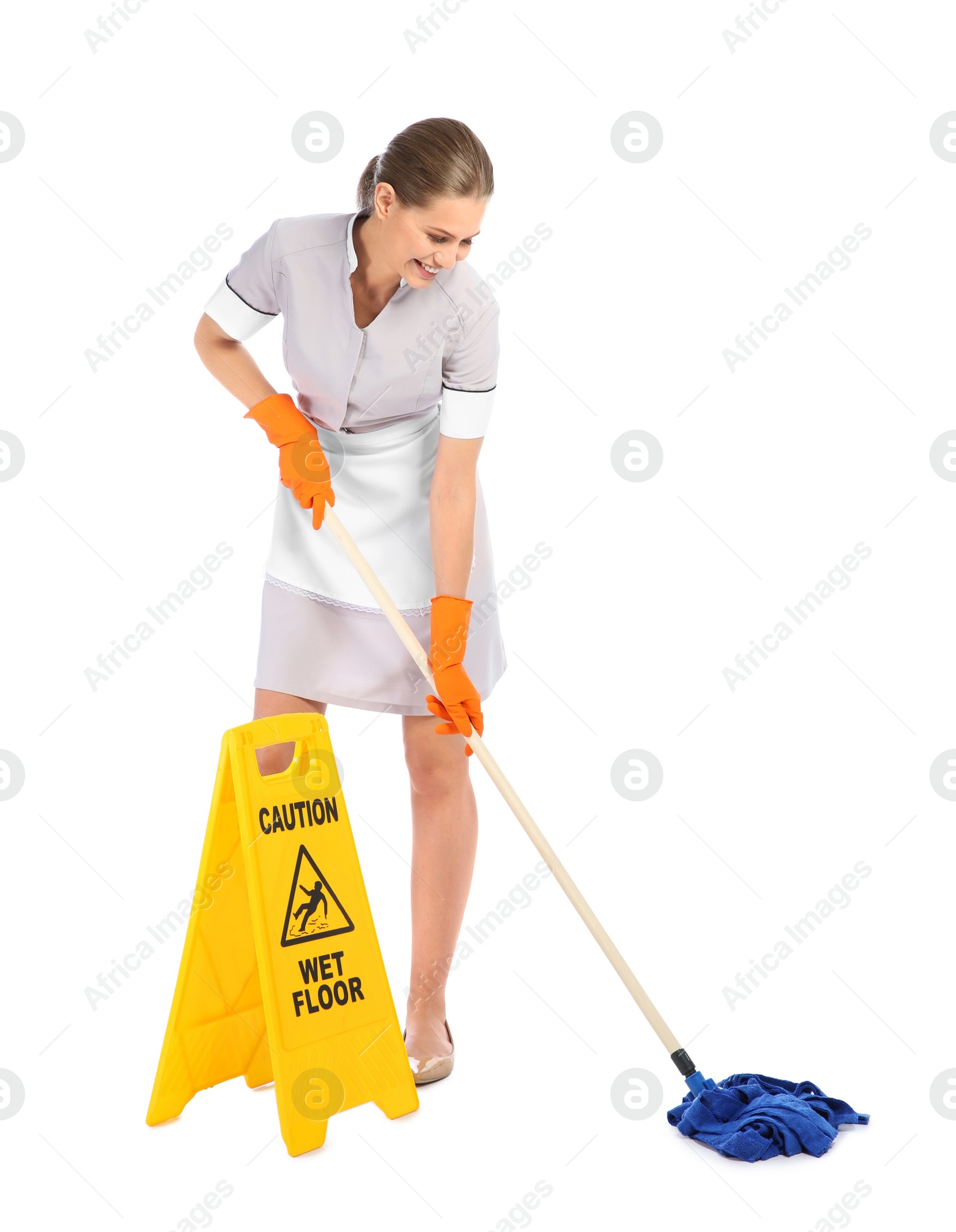 Photo of Young chambermaid with mop near WET FLOOR sign on white background