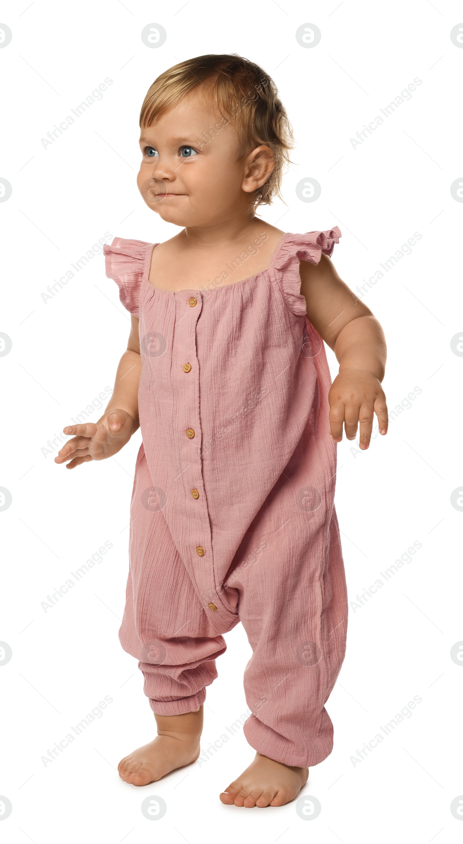 Photo of Cute baby girl learning to walk on white background