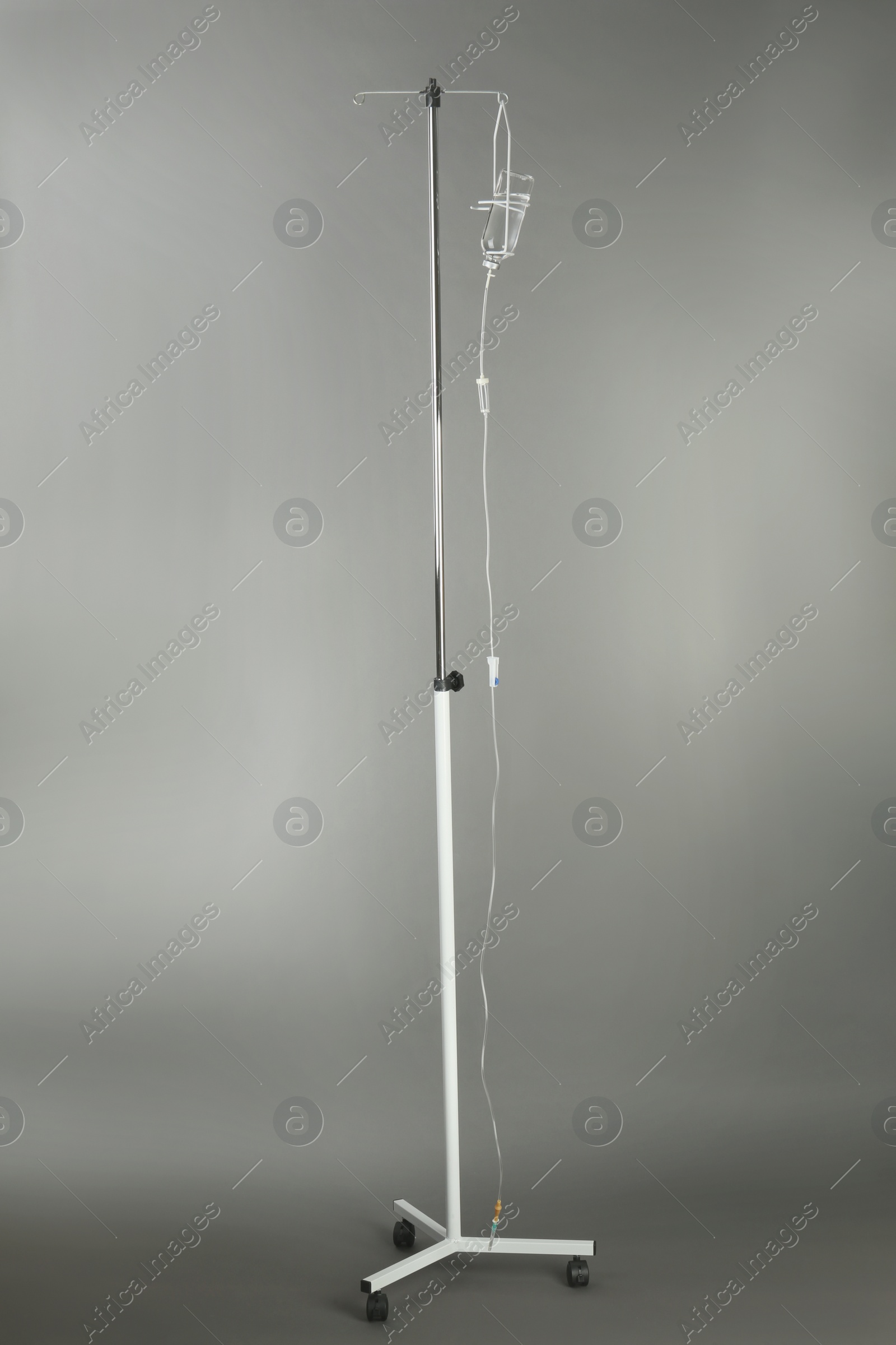 Photo of Drop counter with bottle of medicine on grey background