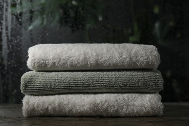 Photo of Stacked terry towels on table in bathroom