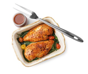 Baked chicken fillets with vegetables and marinade isolated on white, top view