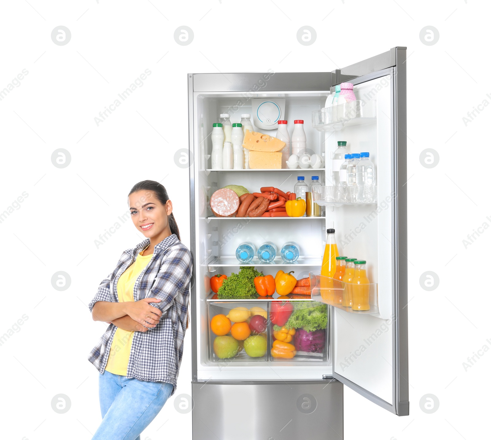 Photo of Young woman near open refrigerator on white background