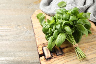 Photo of Bunch of fresh basil on wooden table