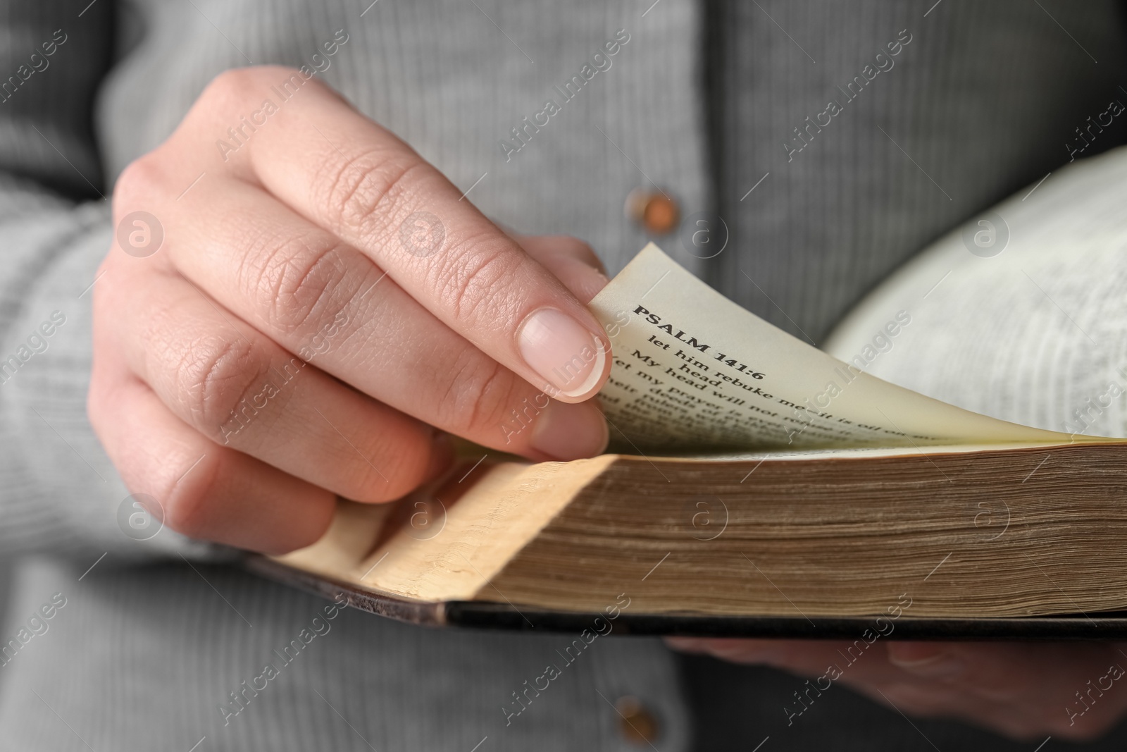 Photo of Woman reading old holy Bible, closeup view