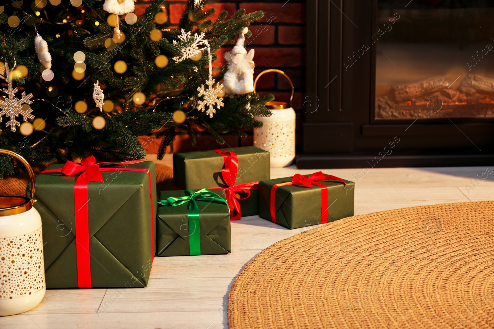 Photo of Beautifully wrapped gift boxes under Christmas tree in living room