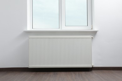 Photo of Modern radiator at home. Central heating system