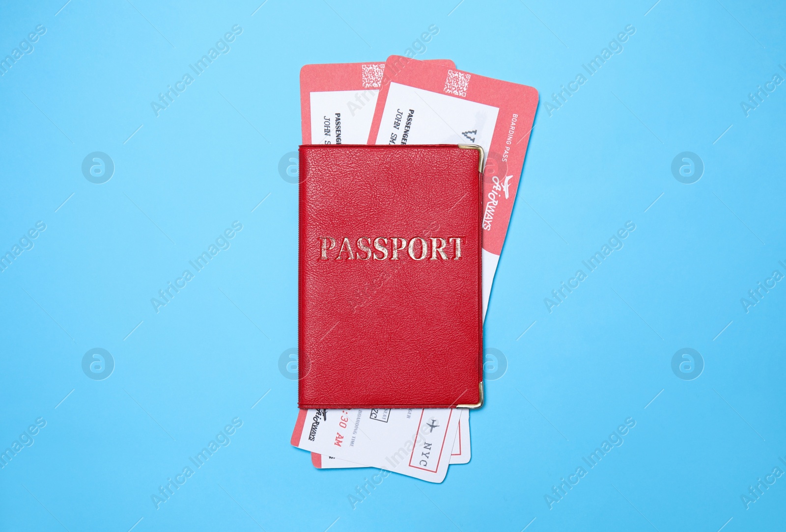 Photo of Passport with tickets on light blue background, top view