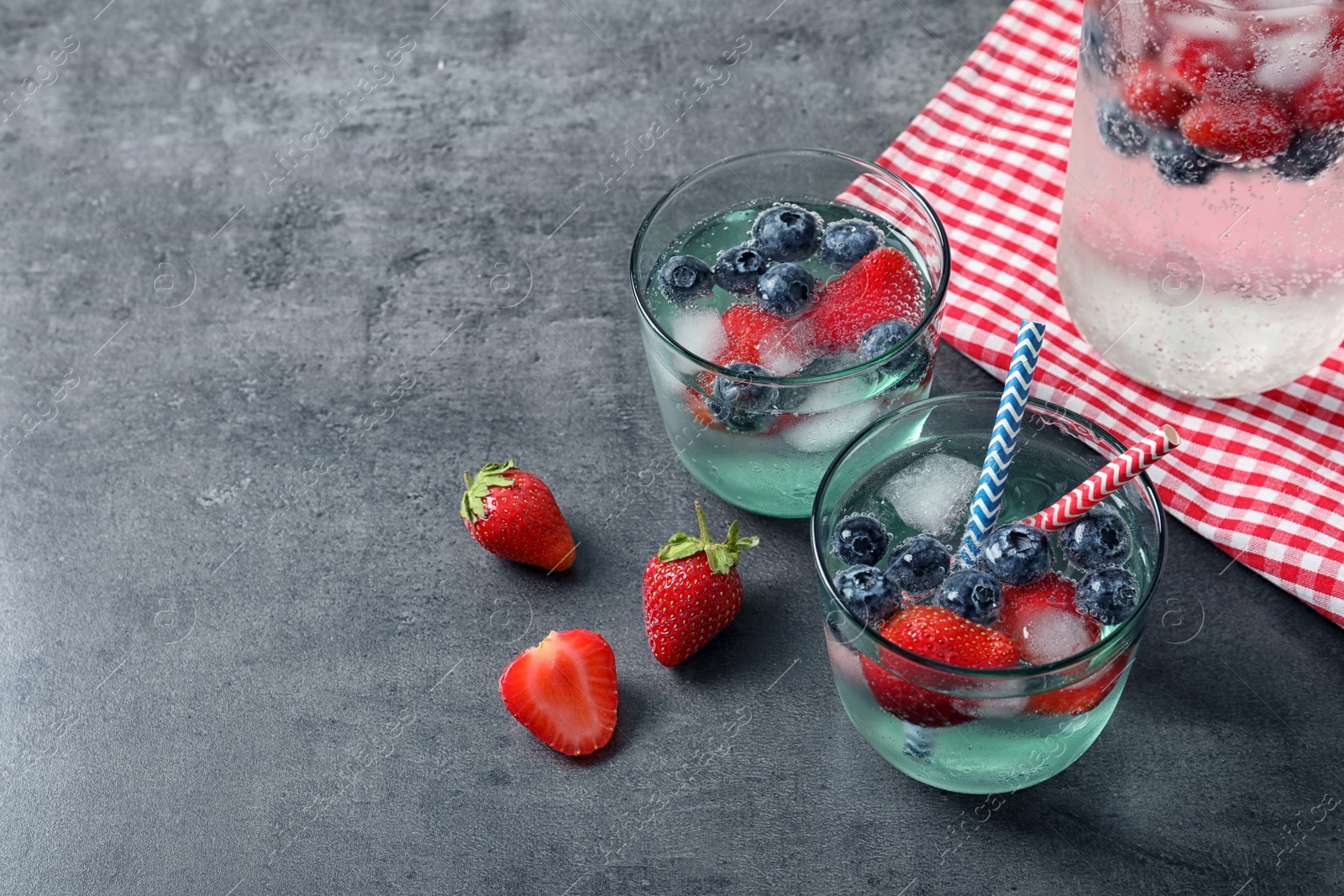 Photo of Glasses of natural lemonade with berries on table