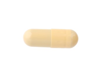 Photo of One vitamin capsule isolated on white, top view