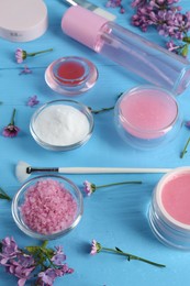 Photo of Homemade cosmetic products and fresh ingredients on light blue wooden table, above view