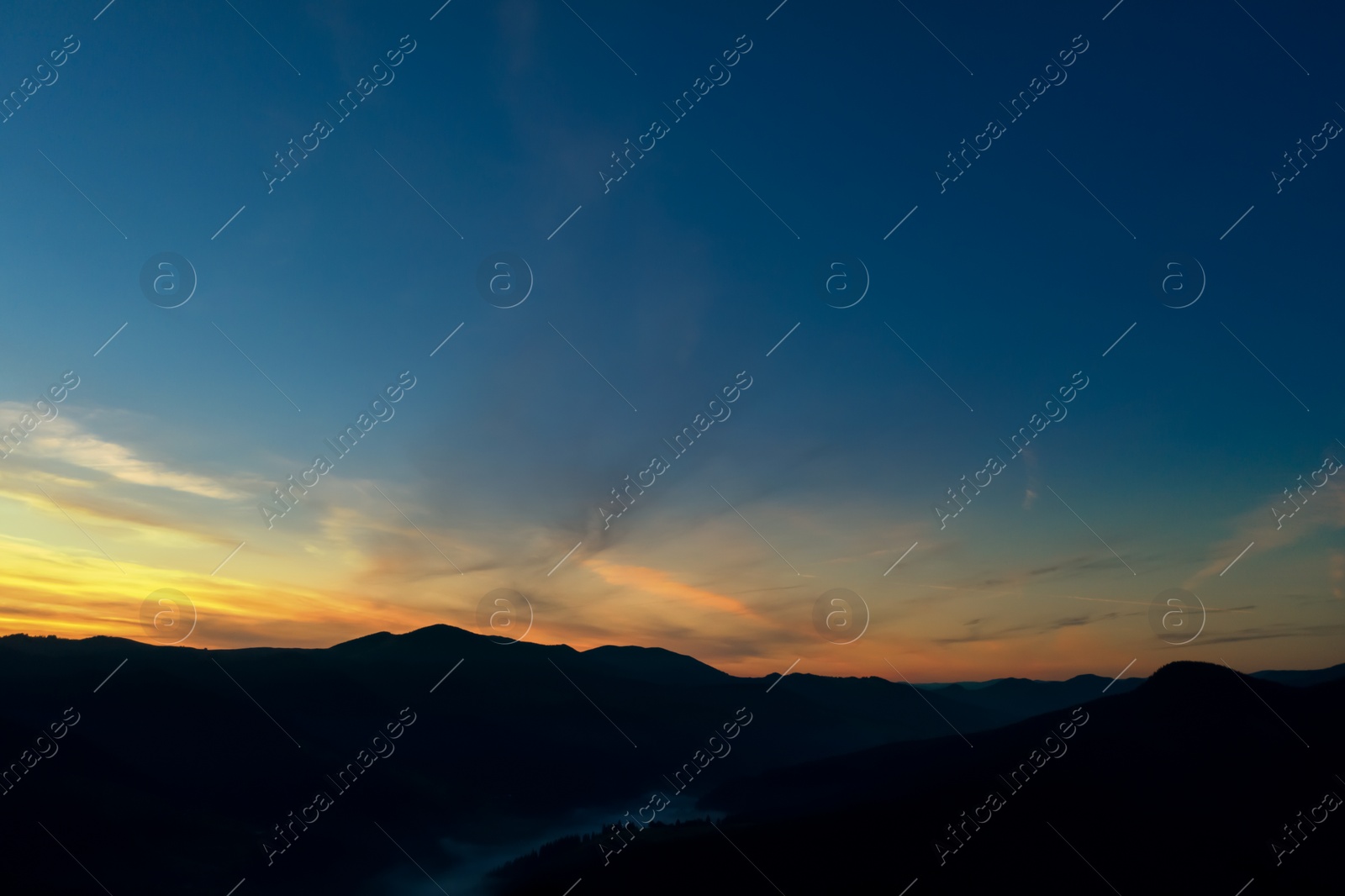 Image of Silhouette of mountain landscape at sunset . Drone photography