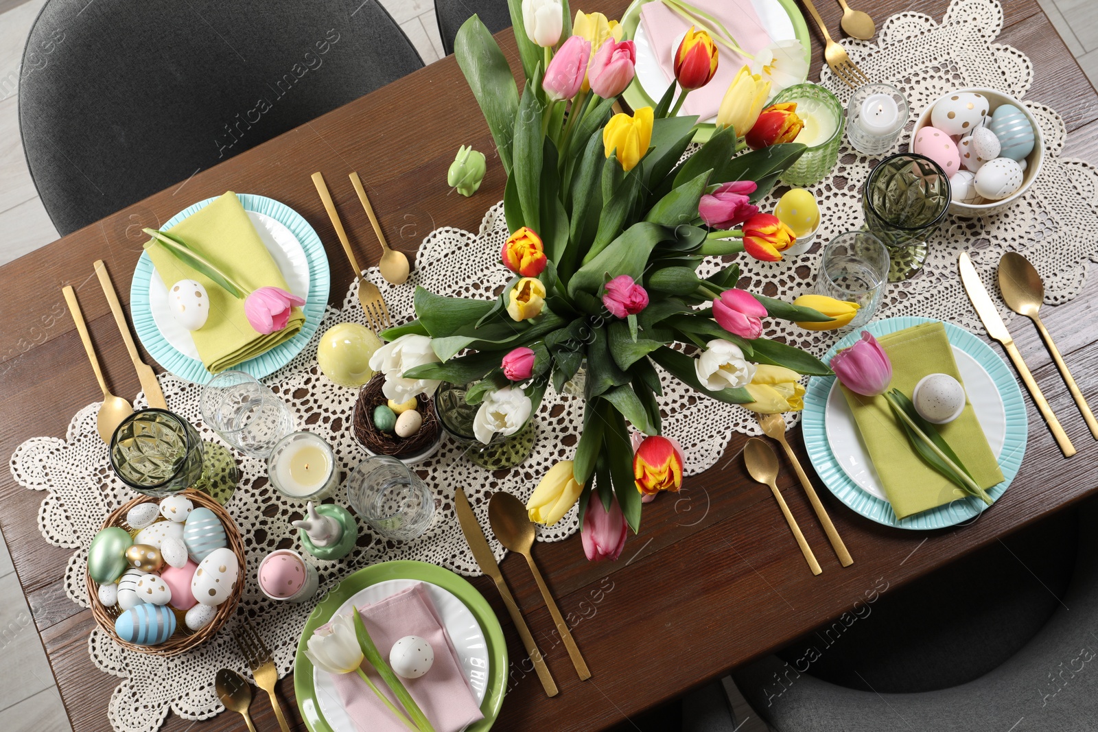 Photo of Festive table setting with beautiful flowers, top view. Easter celebration