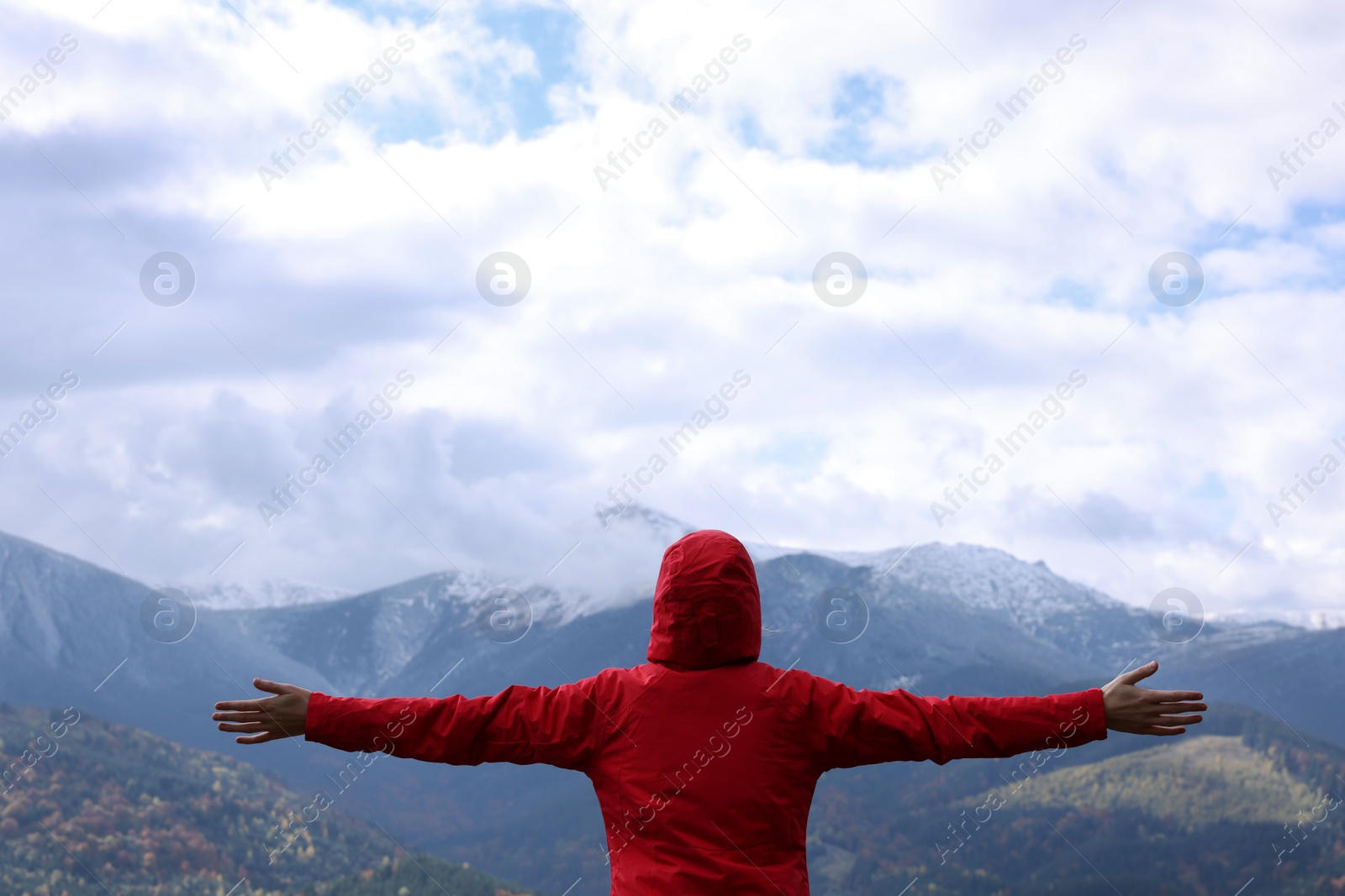 Photo of Happy woman admiring mountain landscape, back view. Feeling freedom