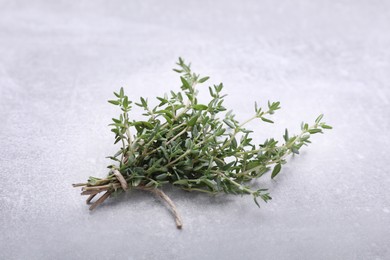 Photo of Bunch of fresh thyme on light grey table