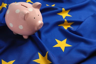 Photo of Pink piggy bank on European Union flag