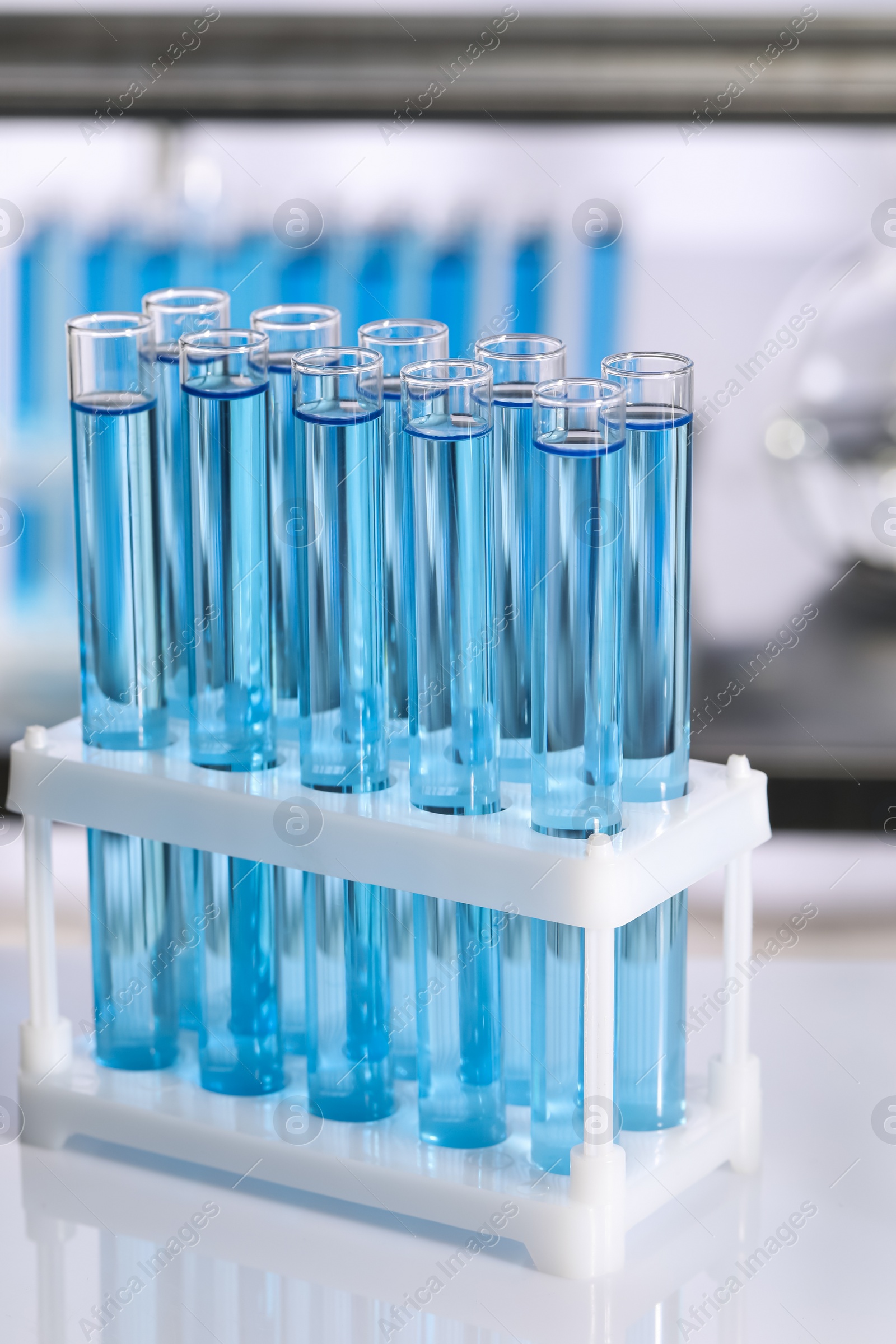 Photo of Test tubes with reagents on table in laboratory