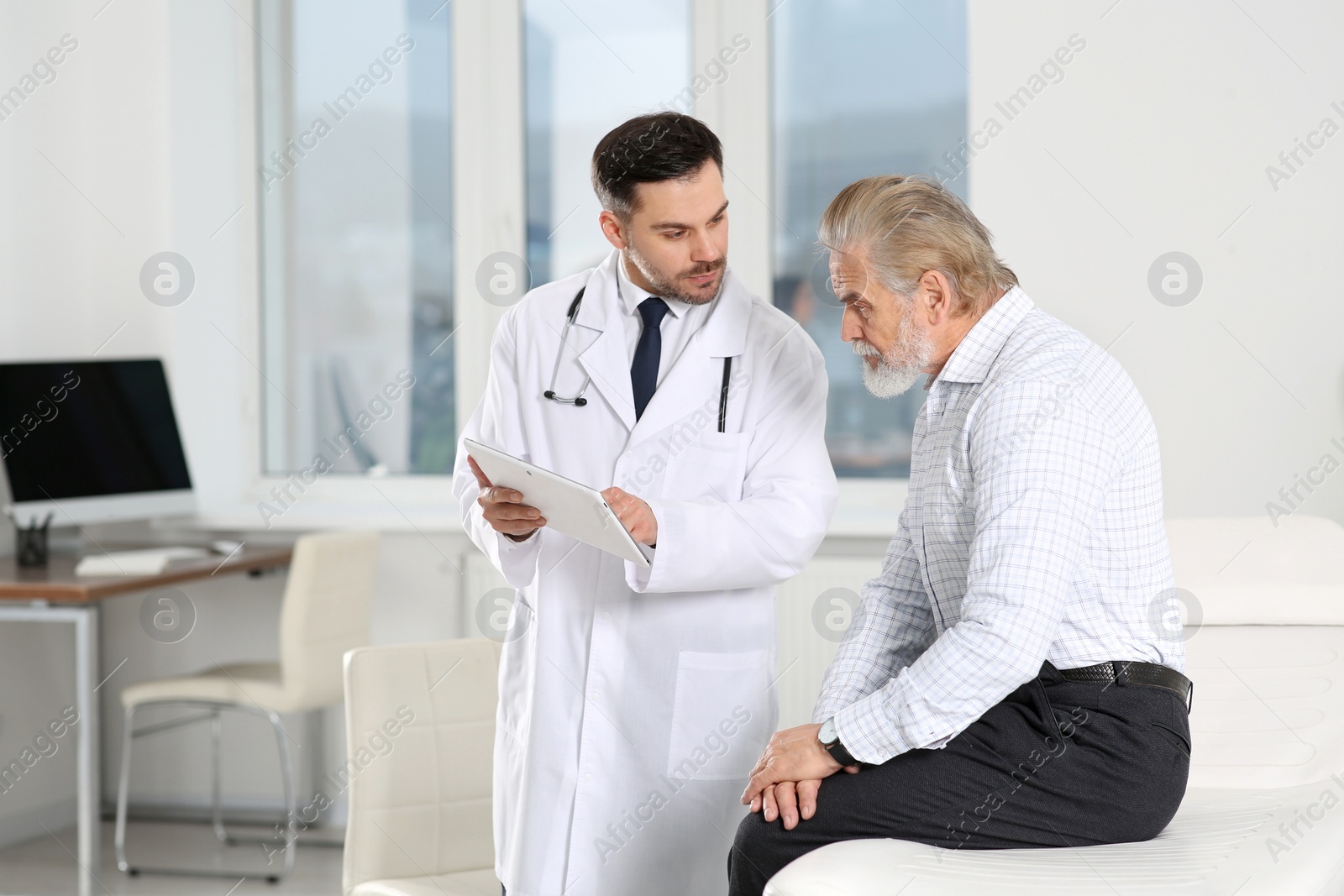 Photo of Senior patient having appointment with doctor in clinic