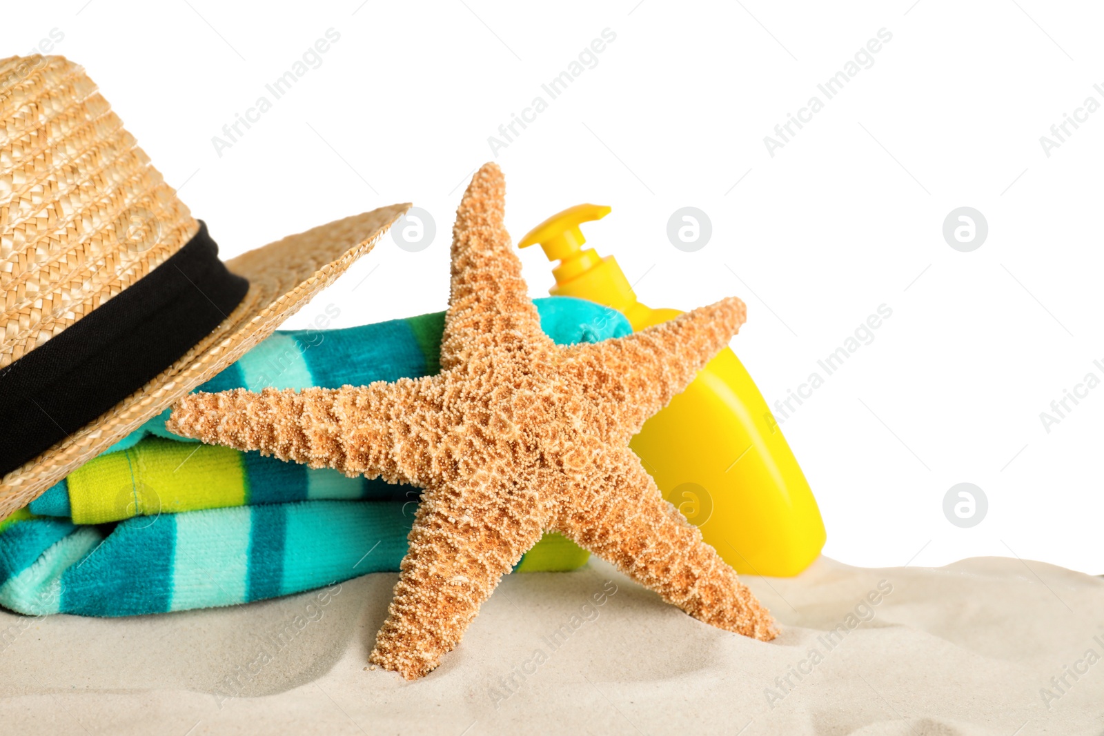 Photo of Beach accessories on sand against white background