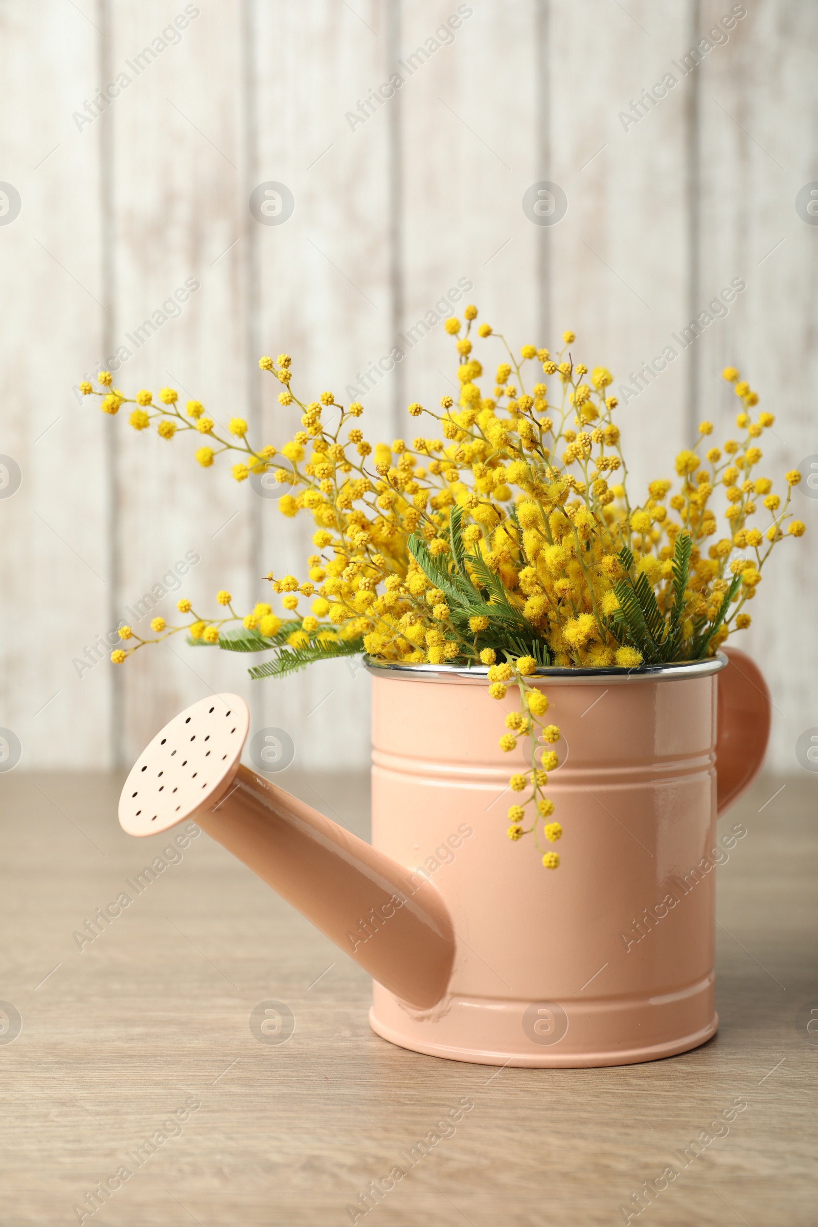 Photo of Bouquet of beautiful mimosa flowers on wooden table