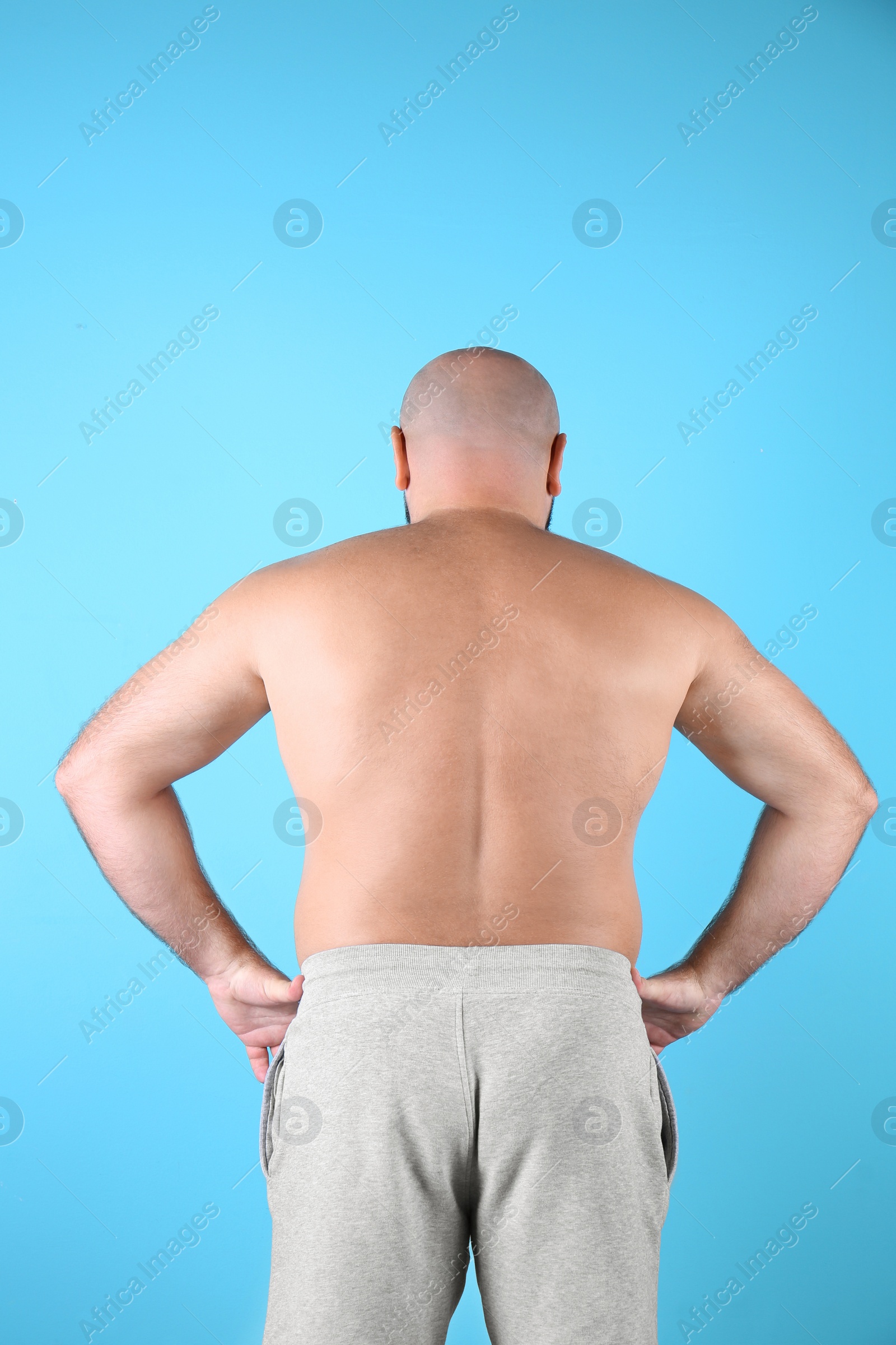 Photo of Fat man on color background. Weight loss