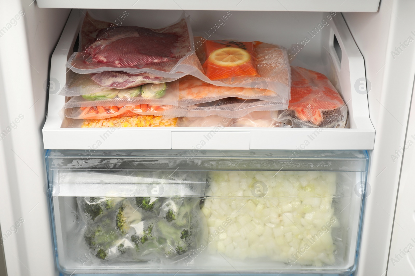 Photo of Vacuum bags with different products in fridge. Food storage