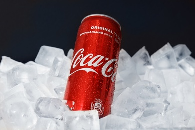 MYKOLAIV, UKRAINE - NOVEMBER 15, 2018: Coca Cola can on ice cubes against black background