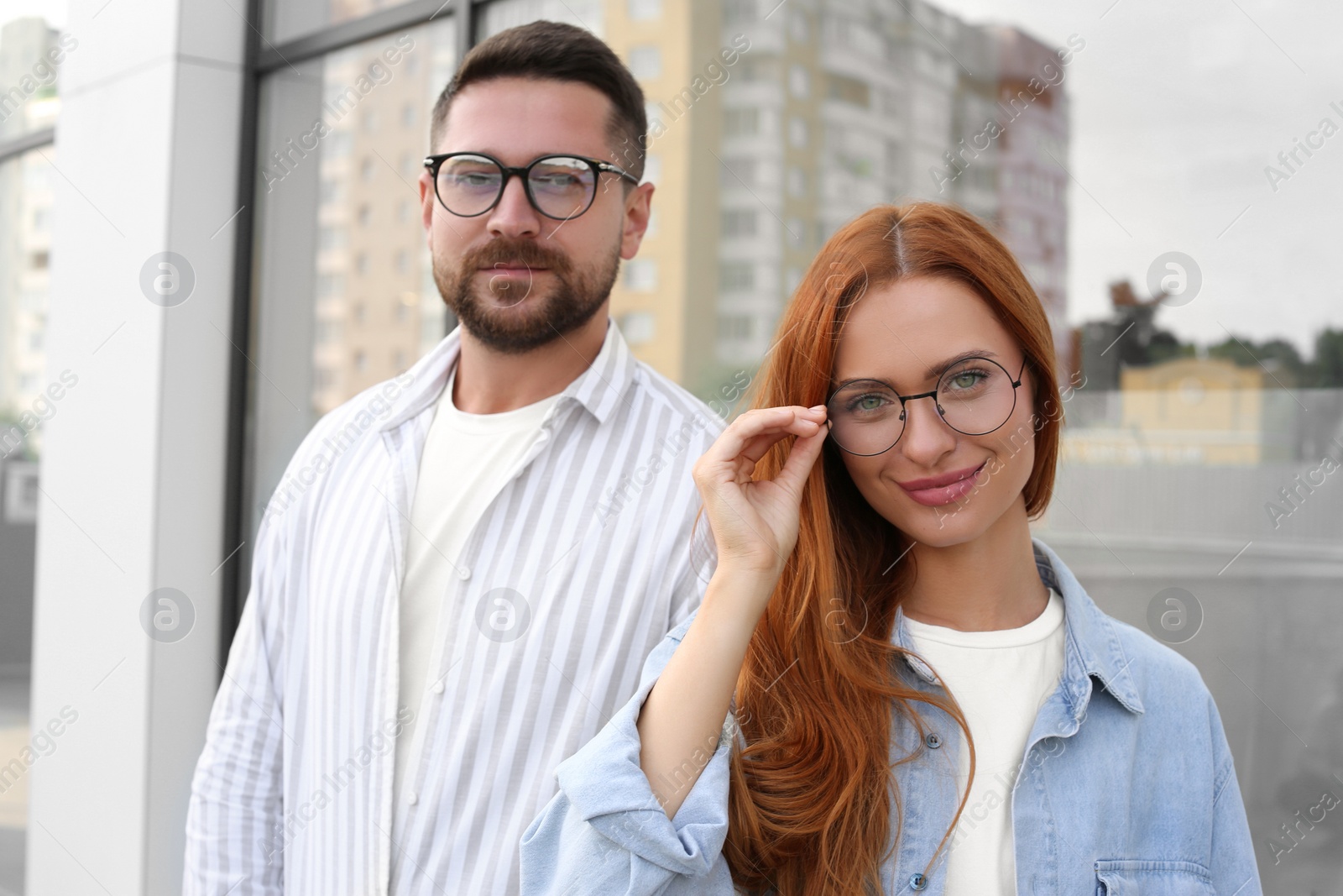 Photo of Portrait of happy couple in glasses outdoors