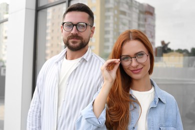 Portrait of happy couple in glasses outdoors