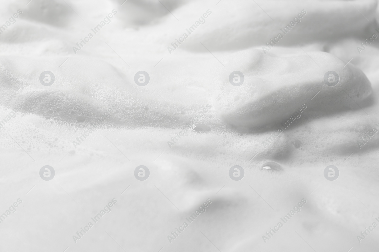 Photo of Foam as background, closeup. Face cleanser, skin care cosmetic