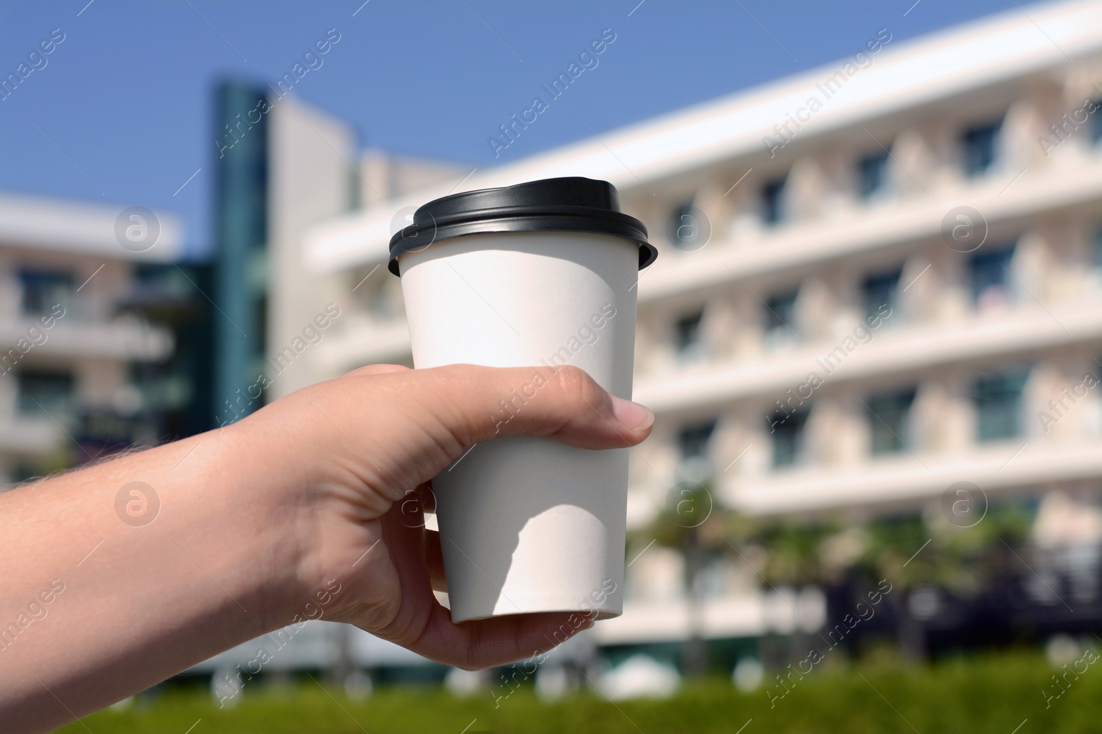 Photo of Woman holding takeaway coffee cup outdoors, closeup. Space for text