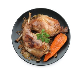 Photo of Tasty cooked rabbit meat with vegetables and parsley isolated on white, top view