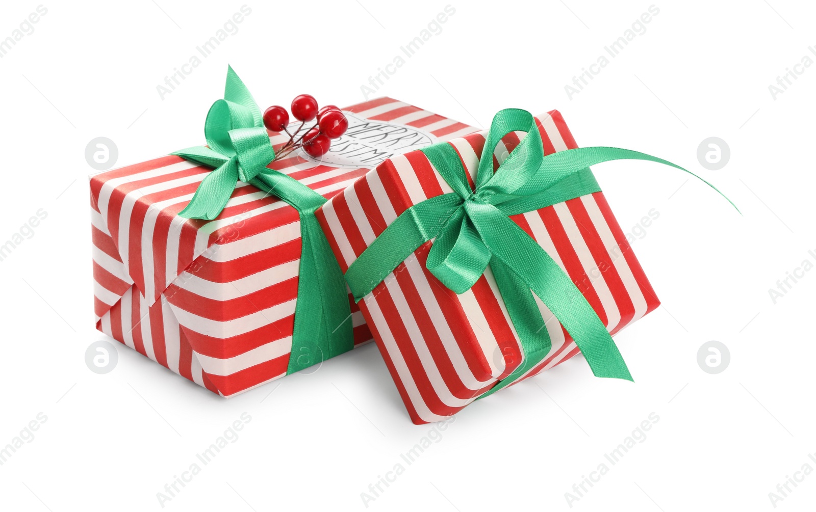 Photo of Christmas gift boxes with green bows and berries on white background