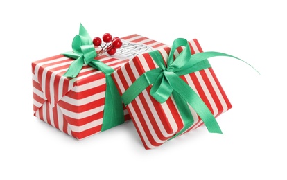 Photo of Christmas gift boxes with green bows and berries on white background