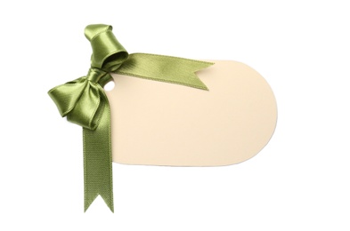 Blank gift tag with satin ribbon on white background, top view