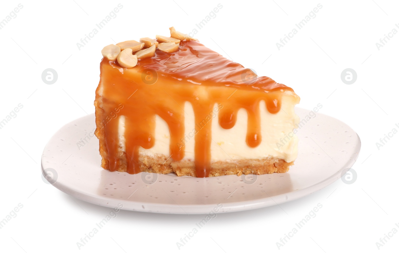 Photo of Piece of delicious cake with caramel and hazelnuts isolated on white