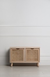 Photo of Wooden chest of drawers near white wall indoors, space for text