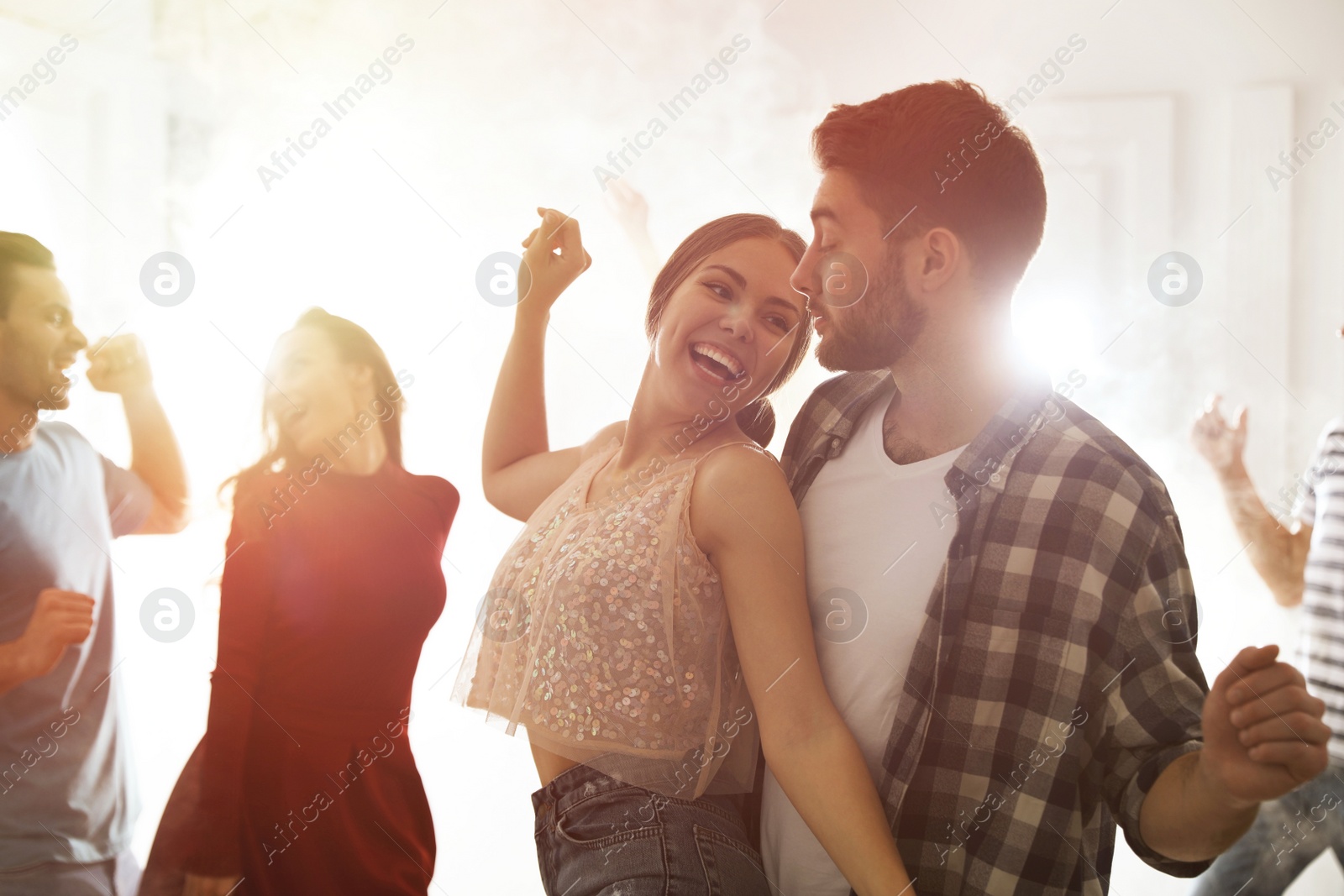 Photo of Lovely young couple dancing together at party