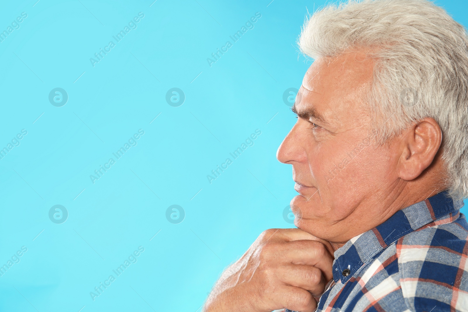 Photo of Mature man with double chin on blue background. Space for text
