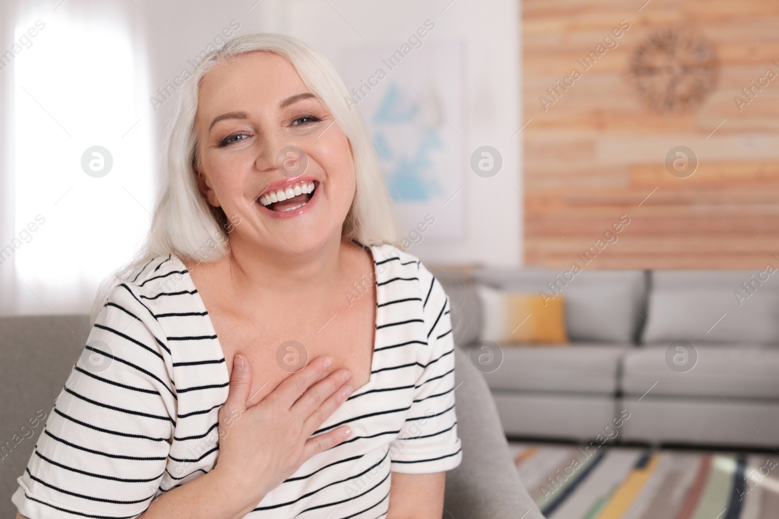 Photo of Portrait of mature woman in living room