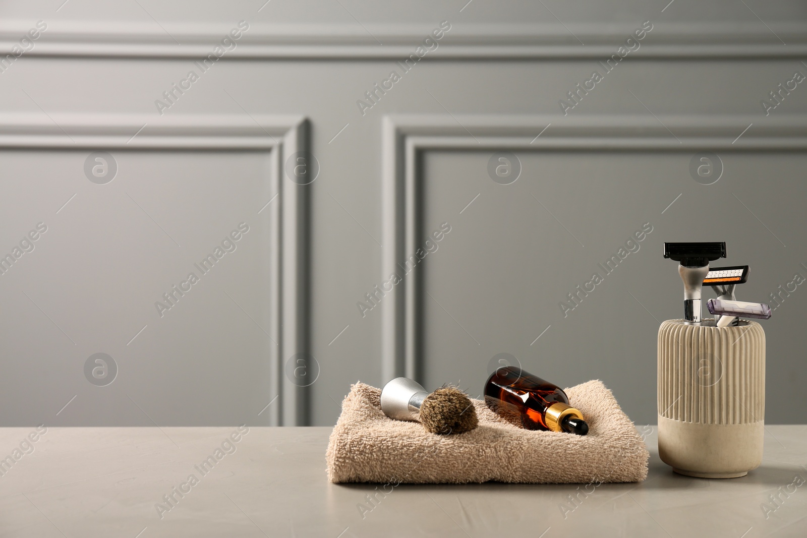 Photo of Set of men's shaving tools on grey table. Space for text