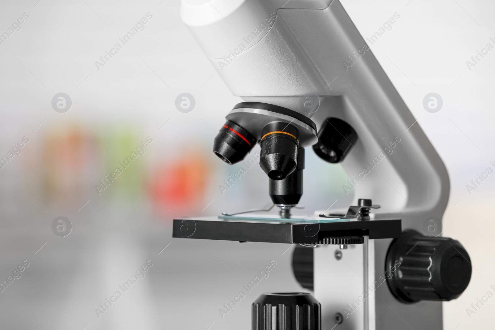 Photo of Modern medical microscope with glass slide on blurred background, closeup. Space for text