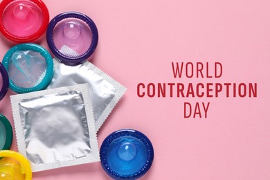 World contraception day. Many colorful condoms on pink background, flat lay