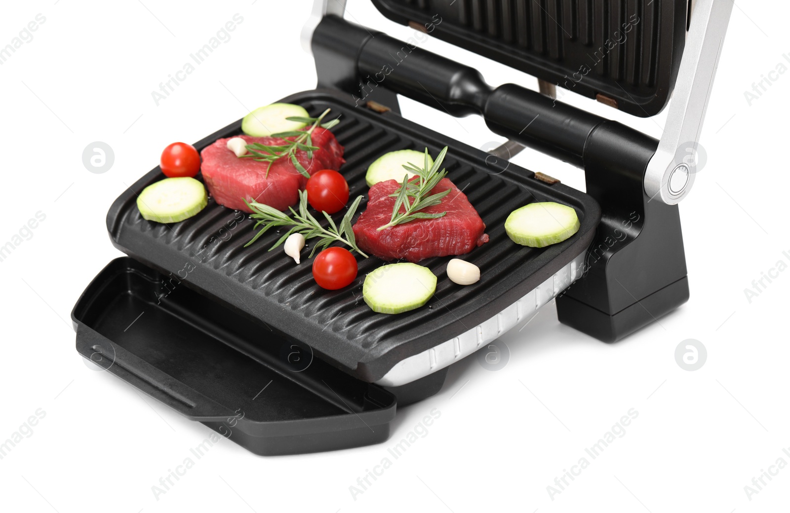 Photo of Electric grill with raw meat, rosemary and vegetables isolated on white