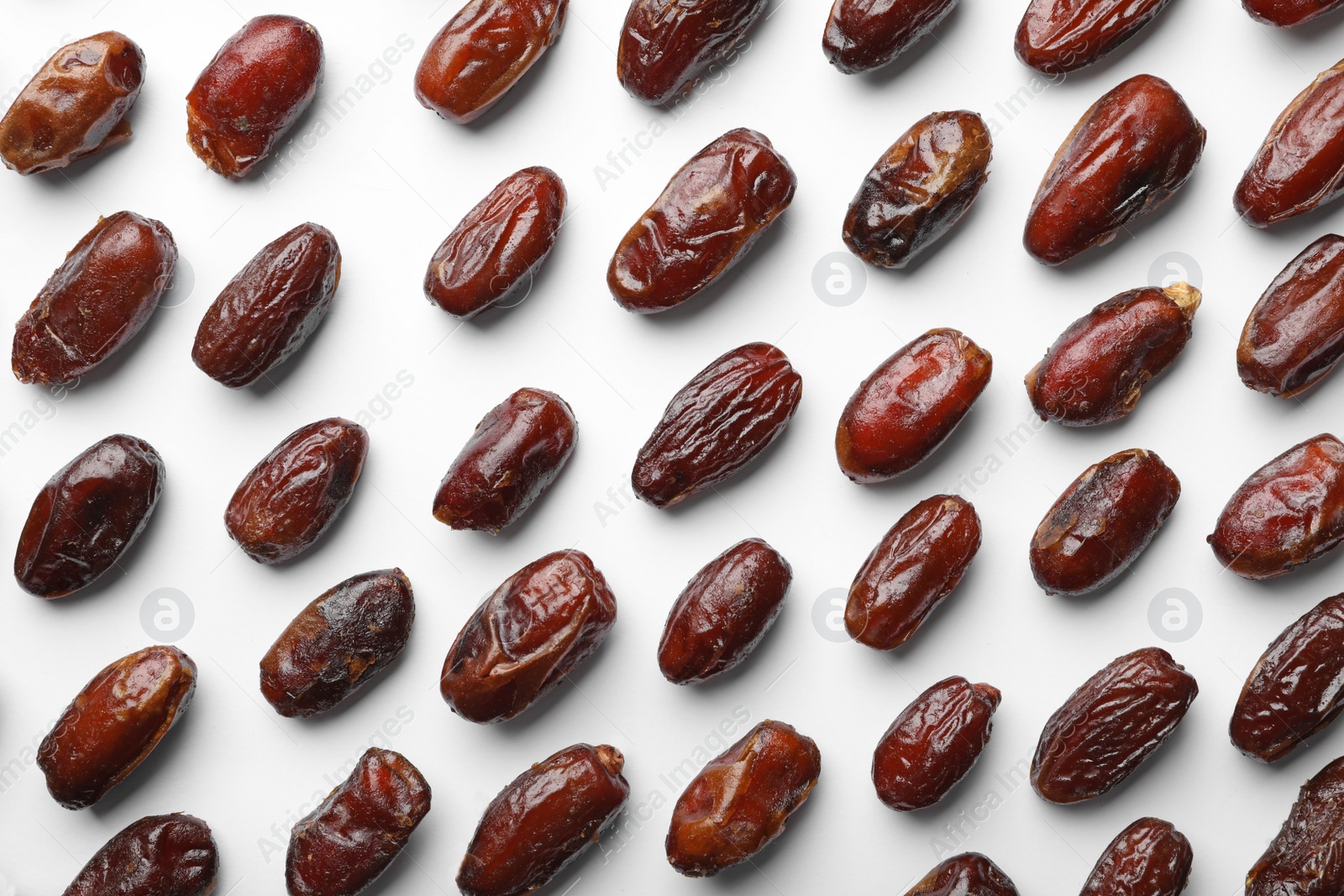 Photo of Sweet dried date fruits on white background, top view