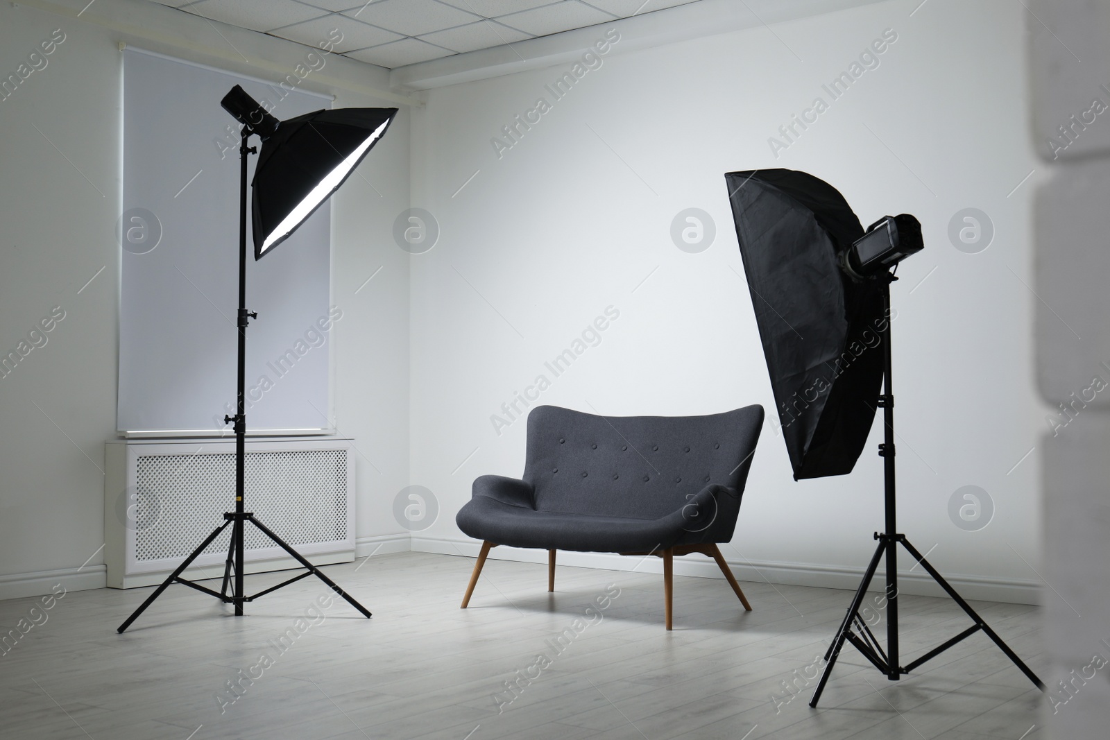 Photo of Modern photo studio with professional lighting equipment